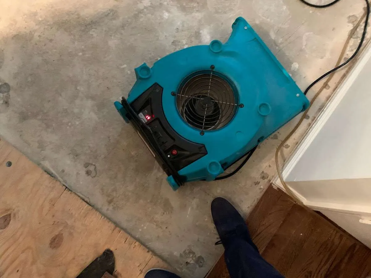 Air mover drying subfloor during Commercial Water Damage Restoration in Dardenne Prairie